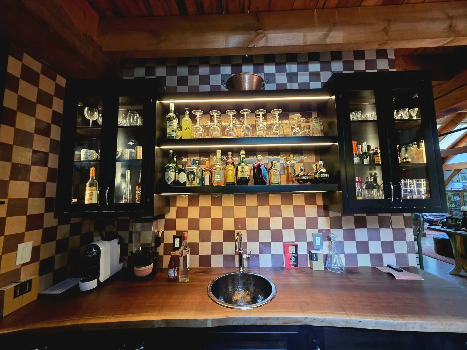 Checkerboard zellige tile backsplash installed behind a home bar