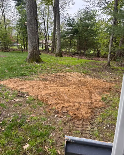 Excavating contractor equipment in action near Hampton, NH