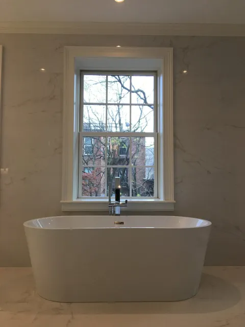 a bathtub in a bathroom next to a window