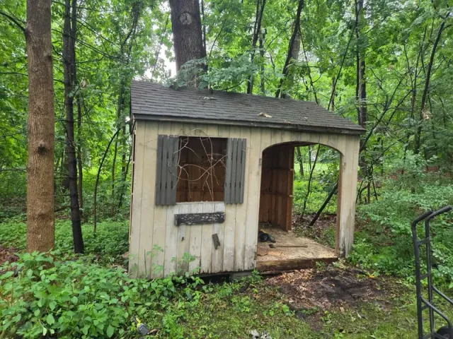 An old shed in the woods before demolition and removal