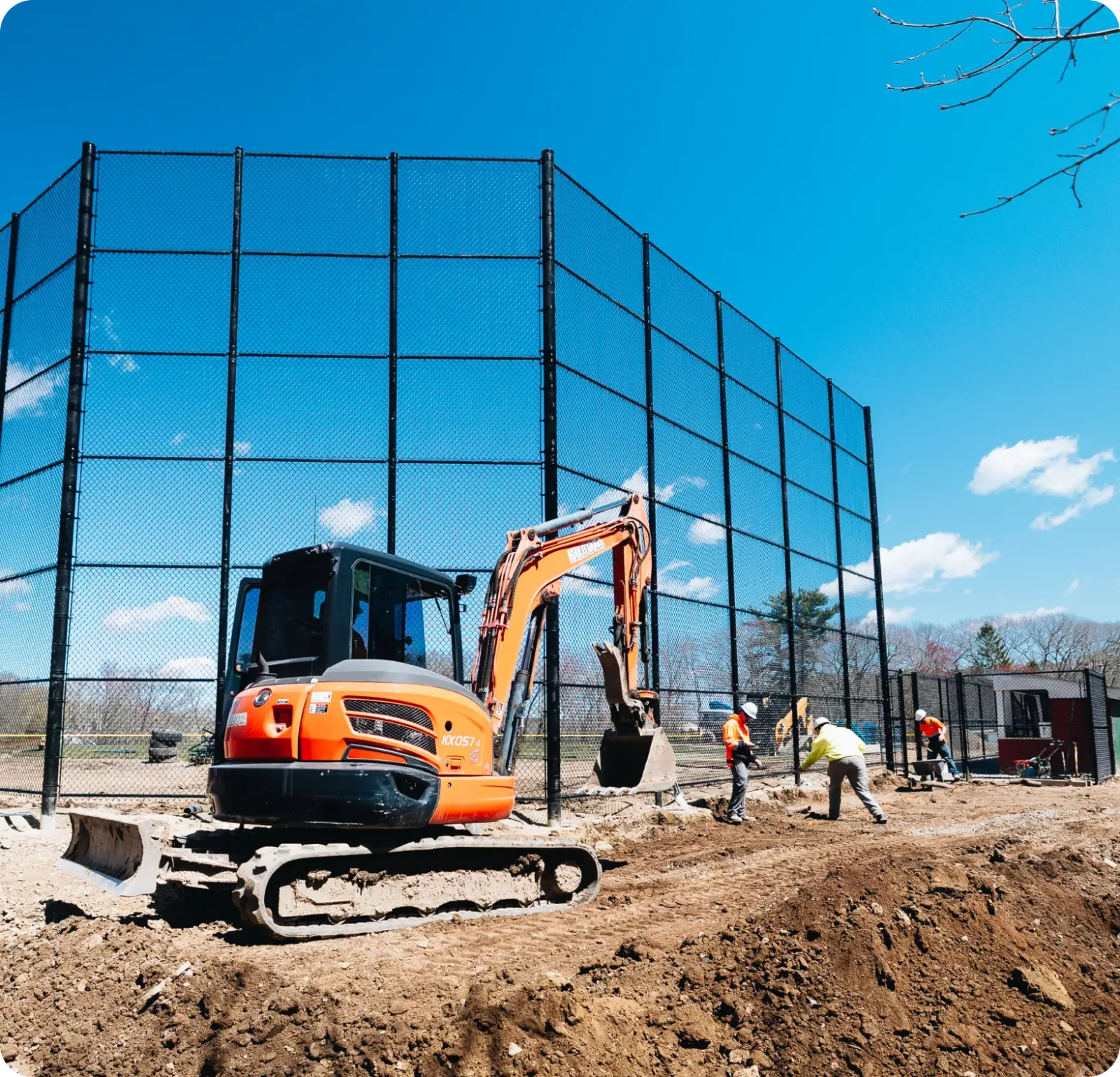 Price Landscape and Construction onsite at a baseball field with a loader and employees