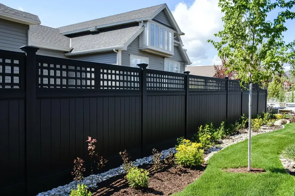 Black vinyl privacy fencing installed by Olympic Fence Co. in a North Shore Massachusetts backyard.