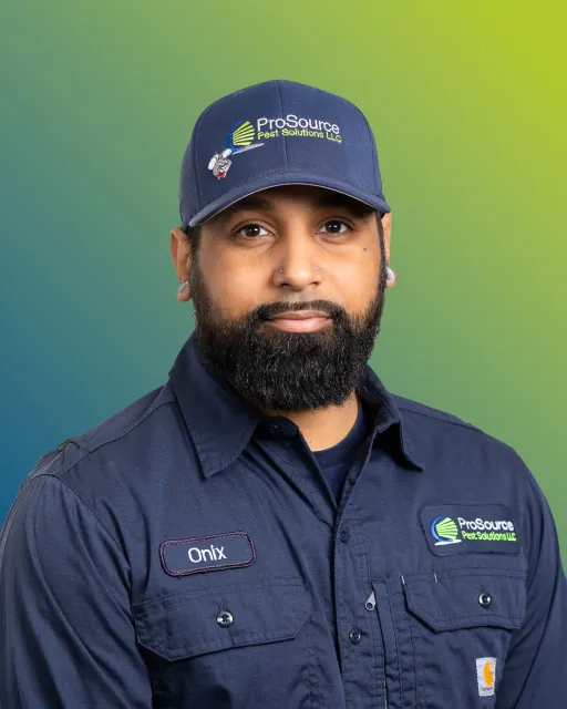 A person in a dark blue work uniform and matching cap with a