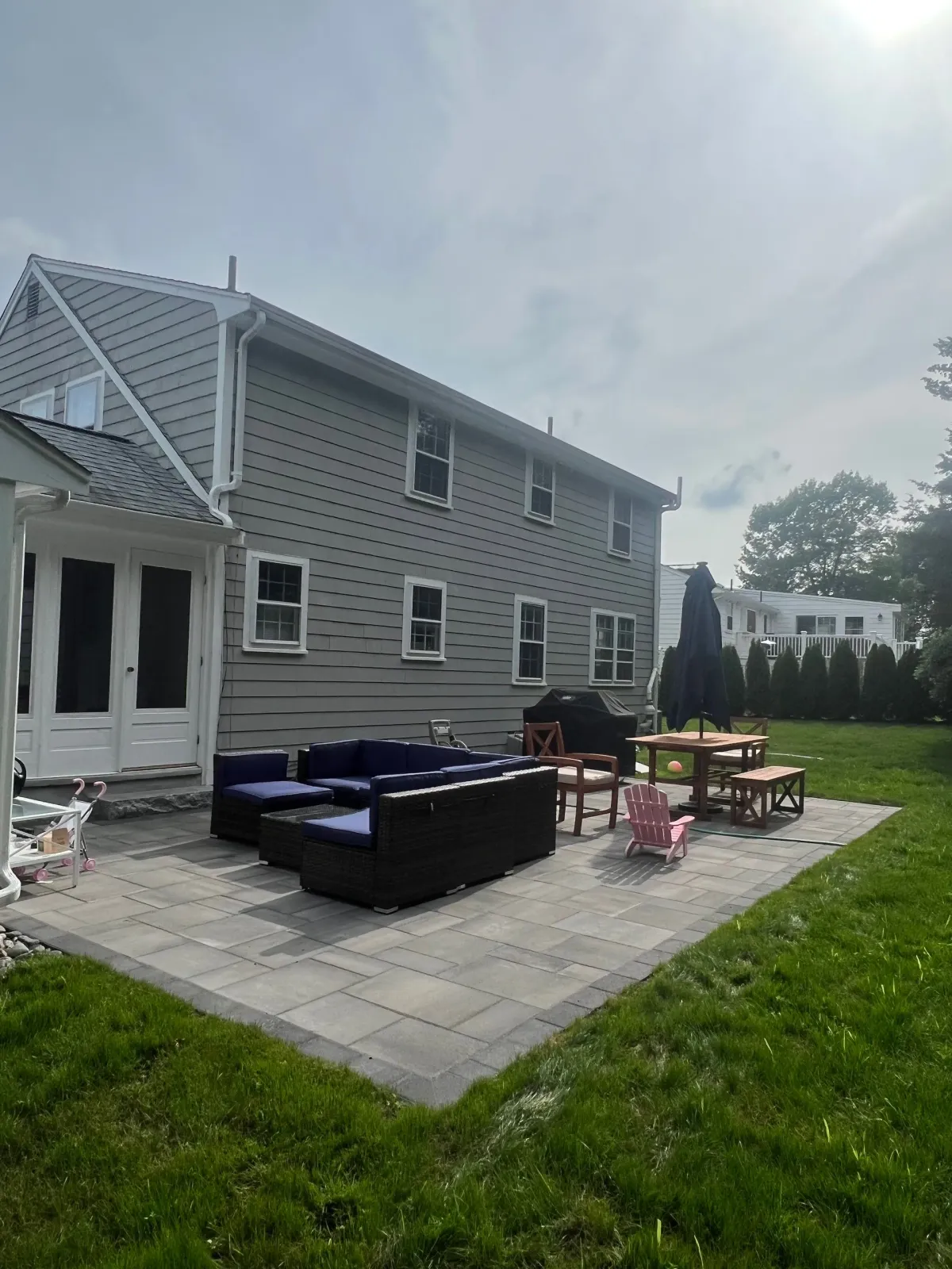 A large house with a patio in front of it.