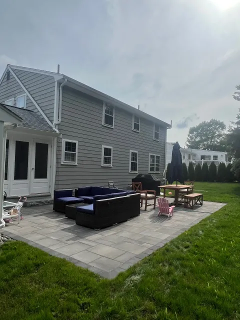A large house with a patio in front of it.