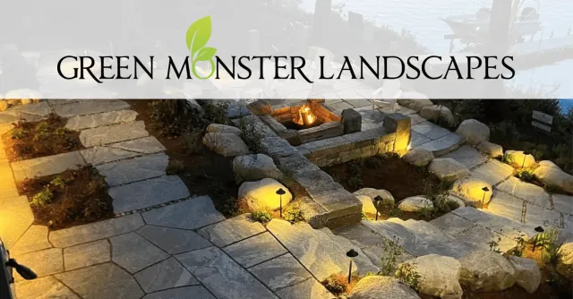 Nighttime landscape lighting and fire pit by the lake