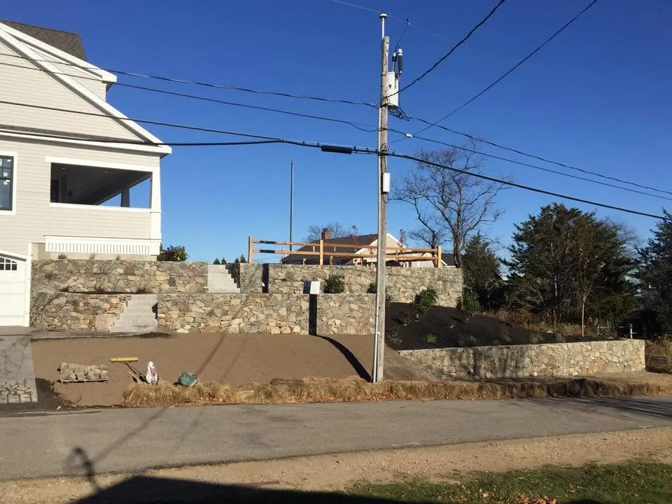 Stone retaining wall along the street frontage