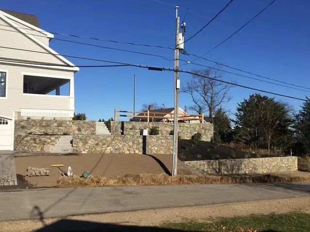 Stone retaining wall along the street frontage