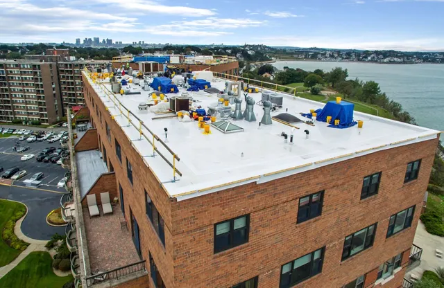 Roof deck work atop a Boston-area apartment building