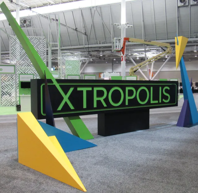 Large XTROPOLIS sign with colorful geometric sculptures