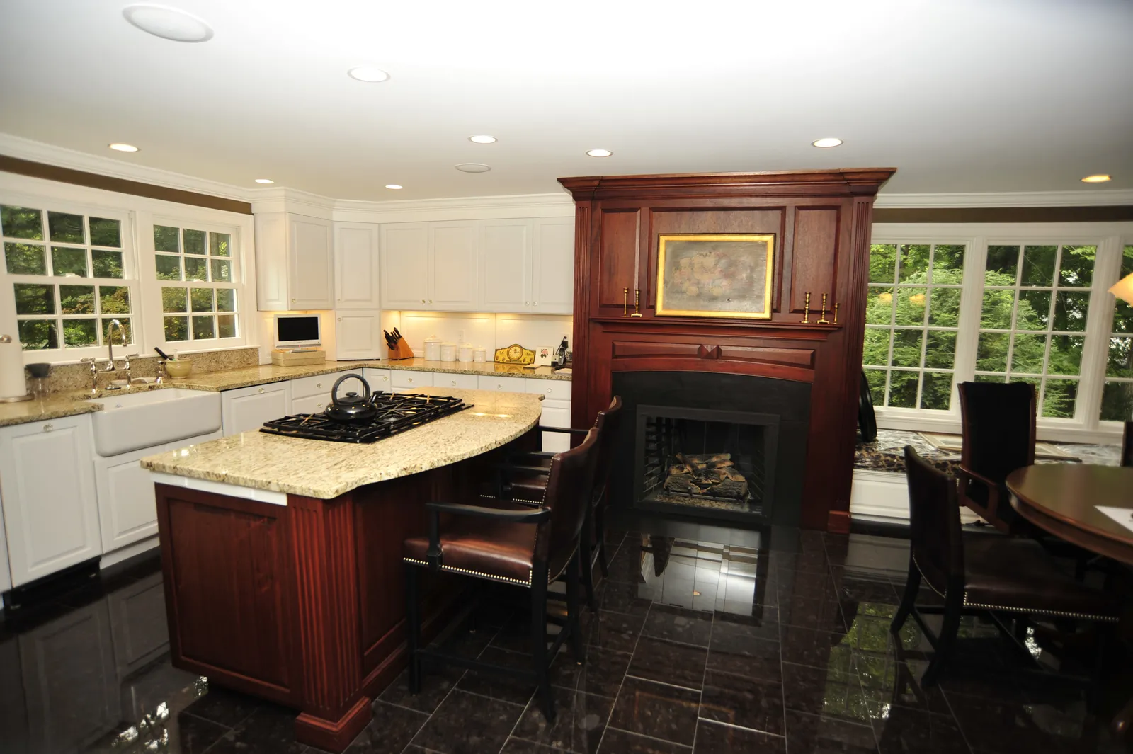 Remodeled kitchen with granite island and cherry mantel