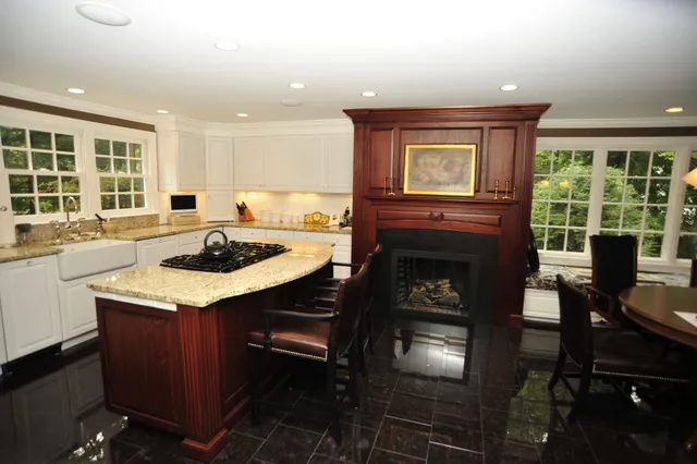 Remodeled kitchen with granite island and cherry mantel
