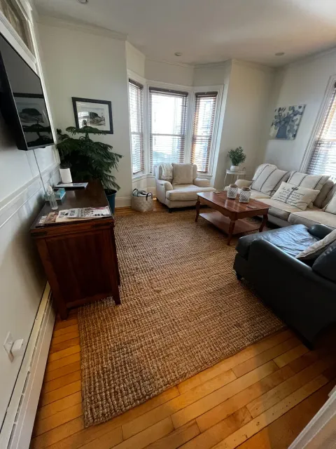 Finished living room with a neutral rug and wood floors