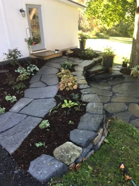 Stone wall and path with shade garden