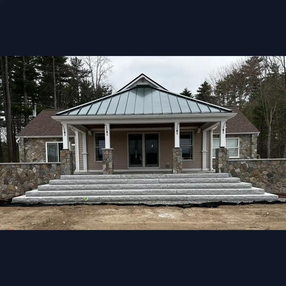 Granite staircase connecting the back yard to the house through a raised patio
