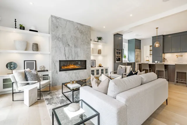 A living room with a white couch and a fireplace