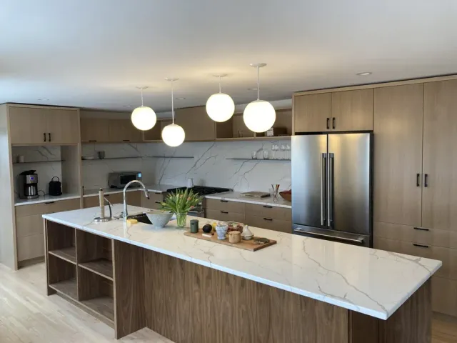 Kitchen featuring light fixtures and granite island