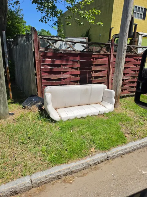 An old couch set out before a Pioneer Valley Junk Removal pickup