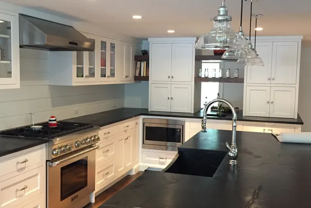 White custom kitchen cabinetry with black stone countertops — Stamford, CT