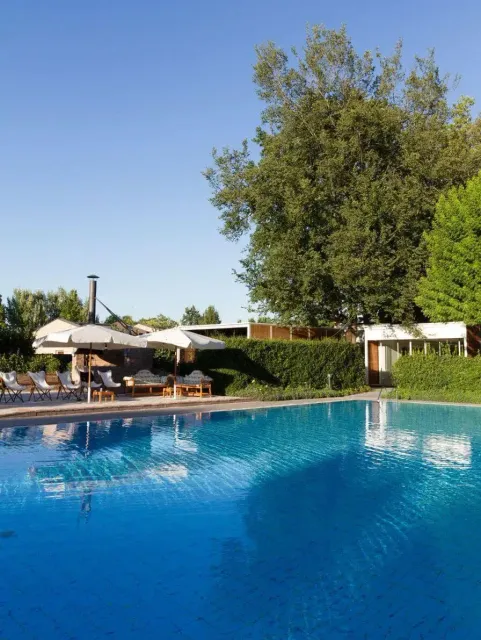 A photo of an in-ground pool on a clear day