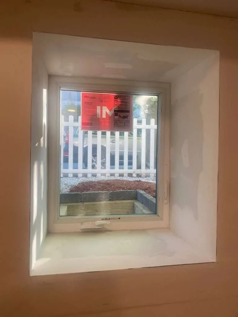 New basement window framed and trimmed from the inside