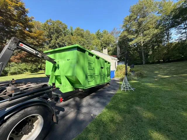 Dumpster being delivered to residential home