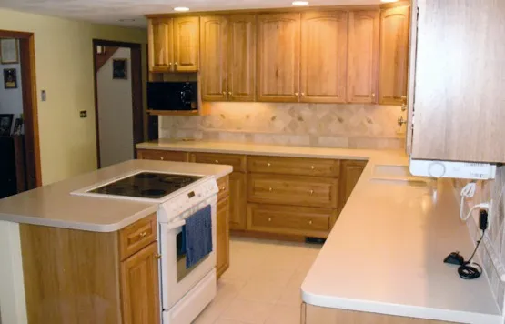 Finished kitchen with peninsula and tumbled-stone backsplash