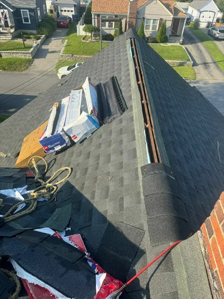 Roof replacement in progress with the work area protected