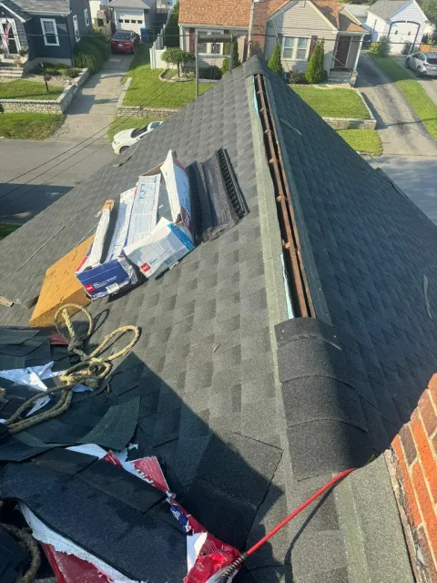 Roof replacement in progress with the work area protected