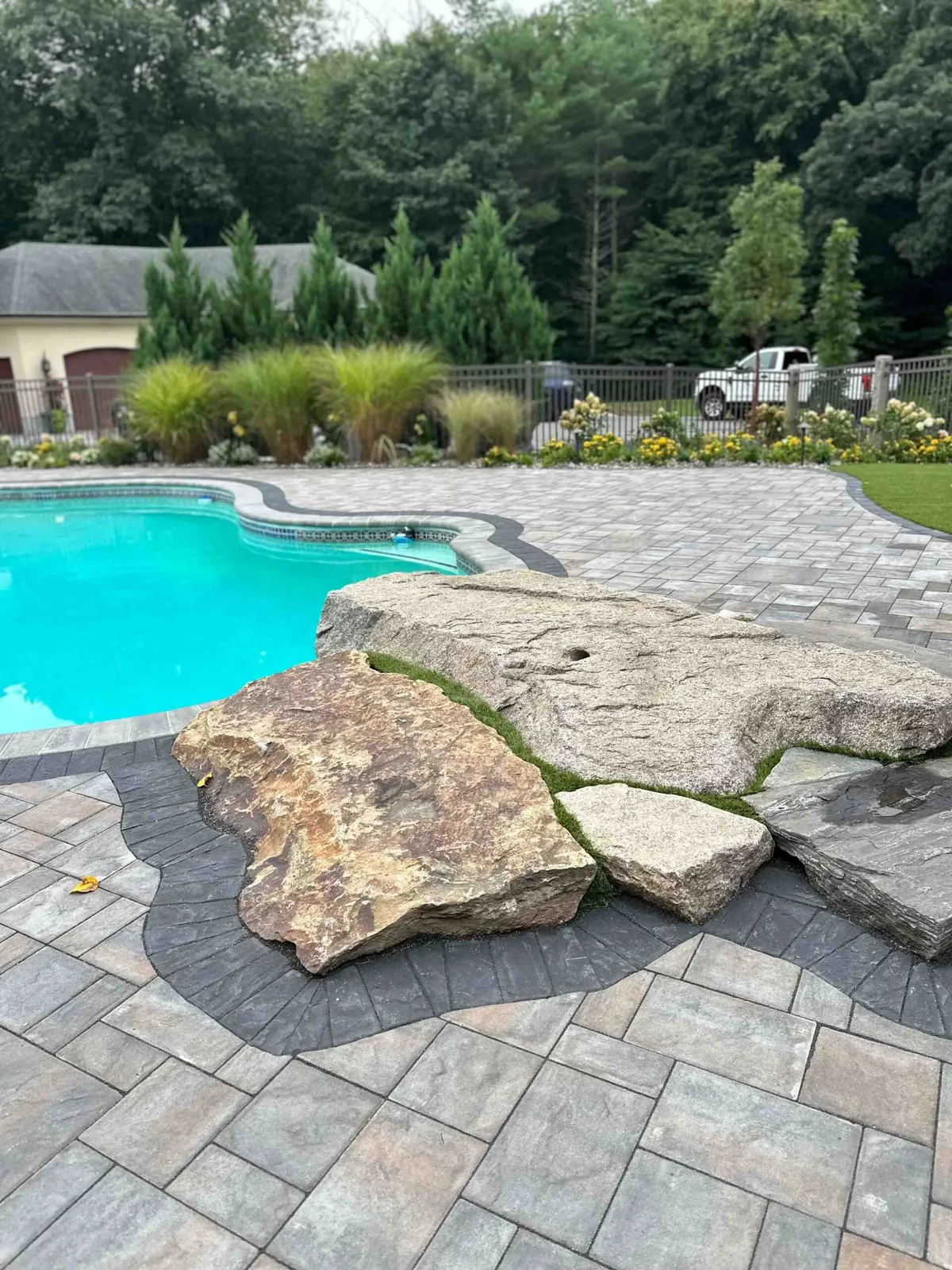 Pool patio hardscape with natural stone accents