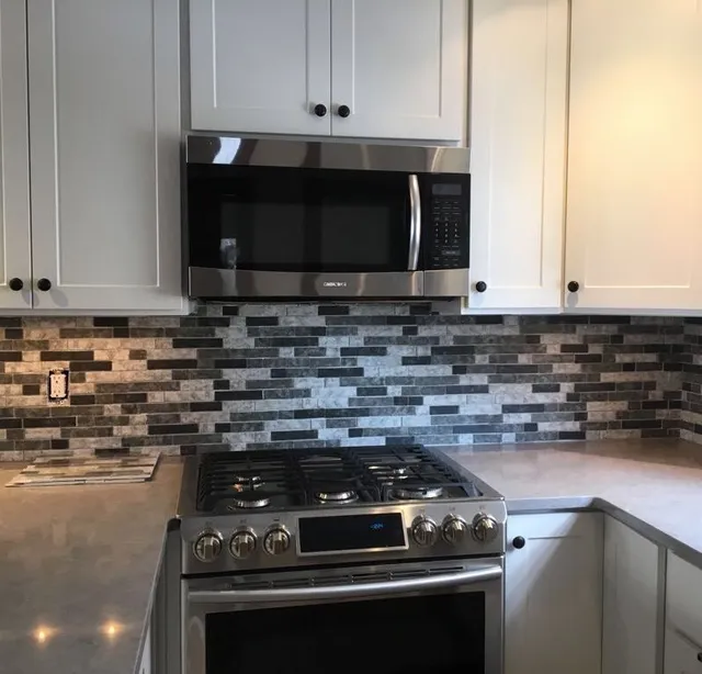 Kitchen remodel with mosaic backsplash and range