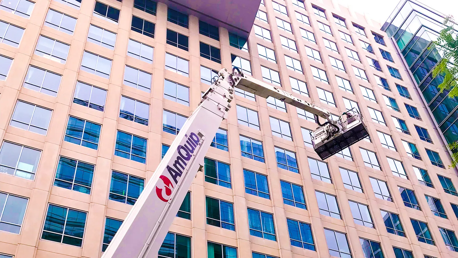 Workers on a lift next to a building