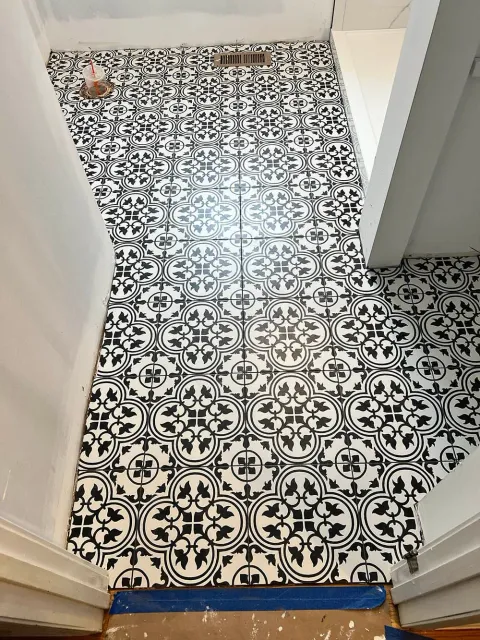 A black and white tile floor in a bathroom.