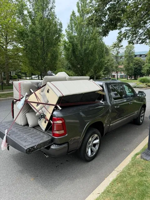 Sectional couch strapped into a pickup bed