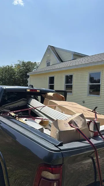 Truck bed loaded with cardboard and building material