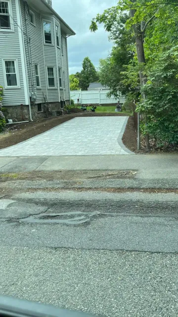Paver border along an asphalt driveway in Massachusetts