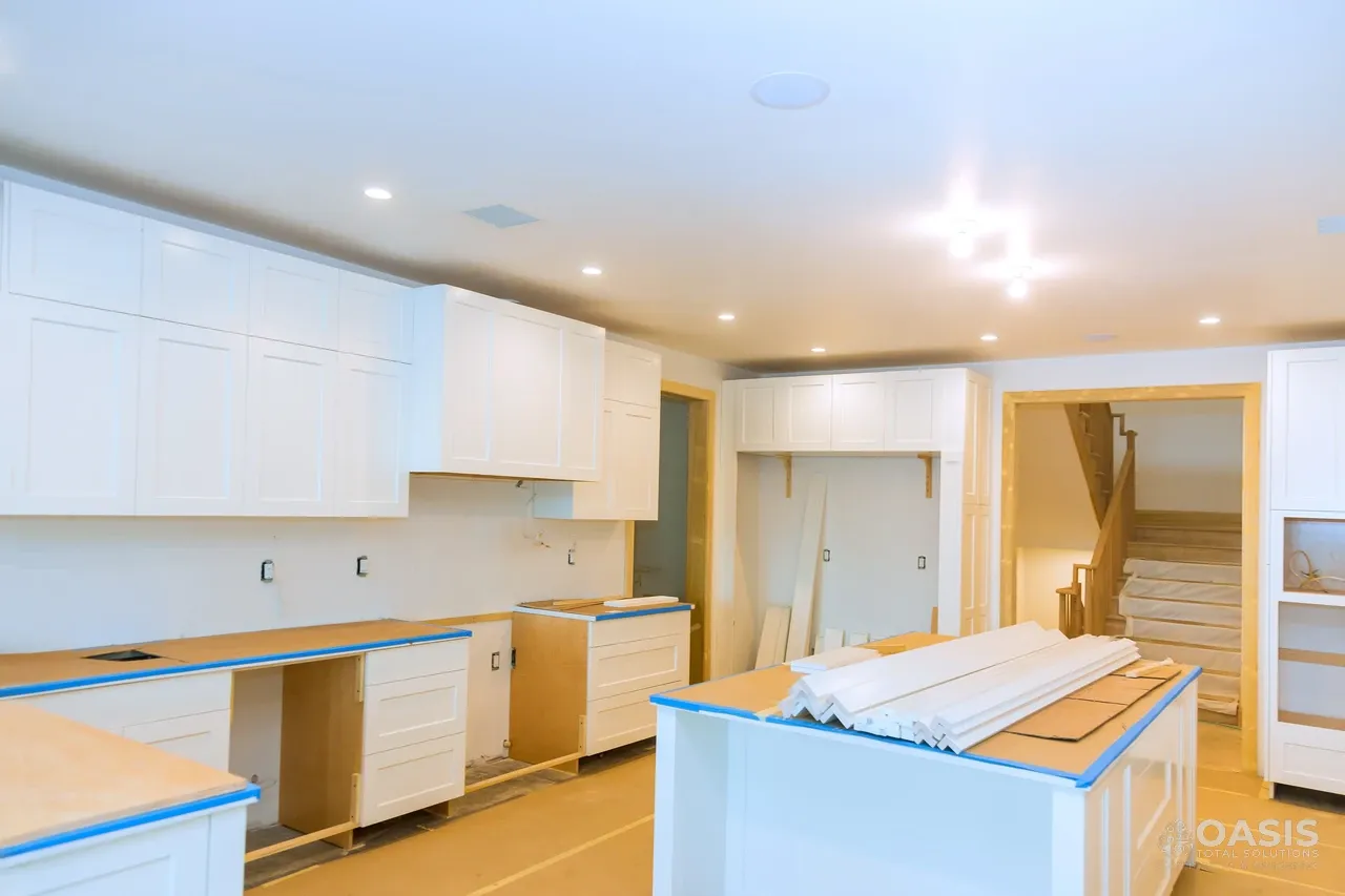 Kitchen installation in progress with white cabinets and island
