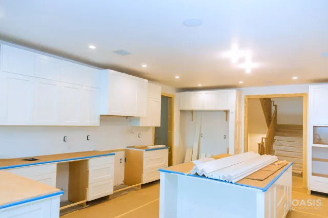 Kitchen installation in progress with white cabinets and island