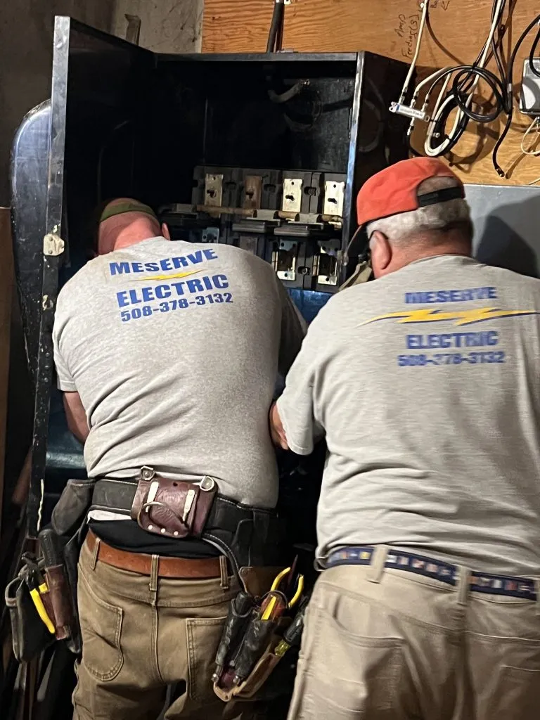 Licensed electricians performing home electrical maintenance