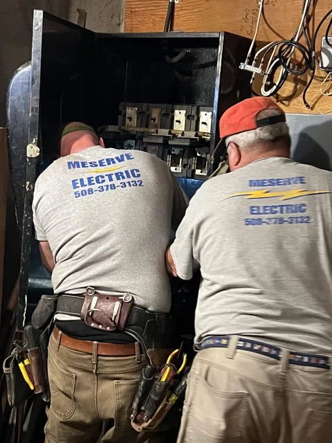 Licensed electricians performing home electrical maintenance