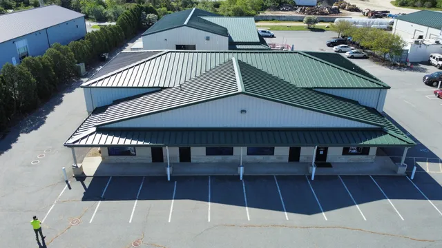 Aerial view of a metal roof restored with a fluid-applied coating system