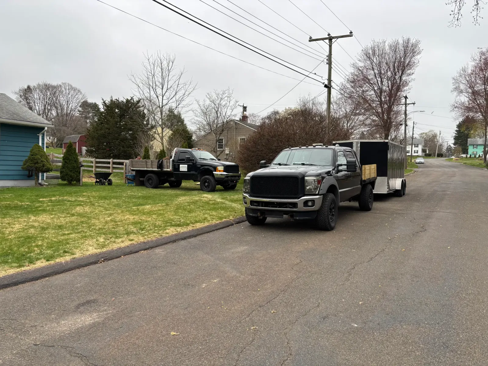 Ibarra Landscape & Construction crew trucks and trailer on a residential job