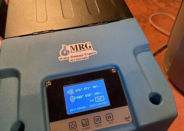 Mass Restoration Group commercial dehumidifier drying a Hampden County, MA property with live moisture readings