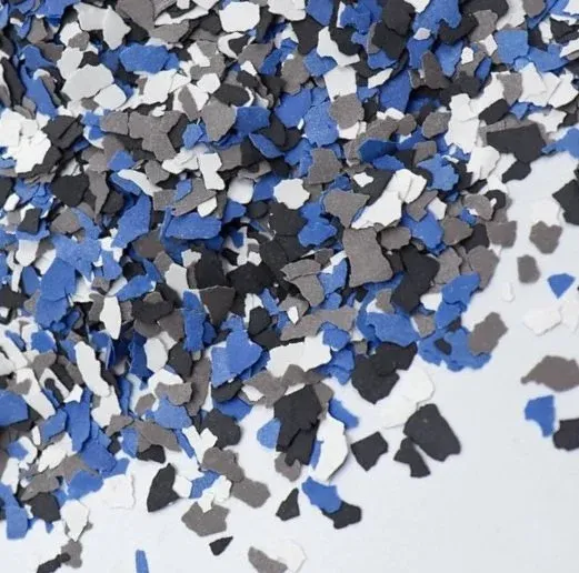 Multicolored confetti in shades of blue, black, gray, and white scattered on a surface.