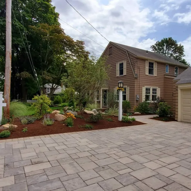 a large brick house with a large driveway in front of it