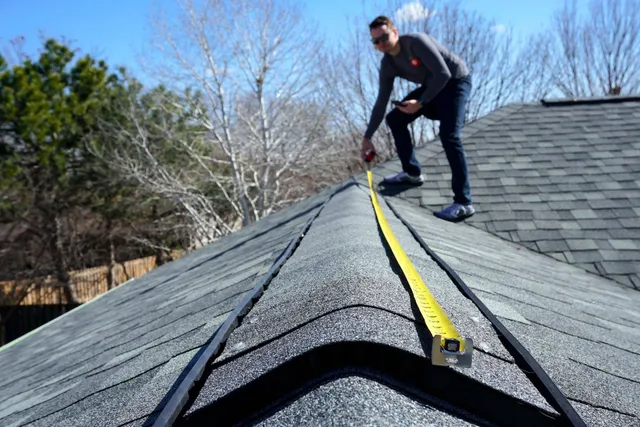 Everlast roofer measuring an asphalt shingle roof during an inspection