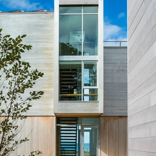 Contemporary home front tower elevation with large glass windows on Cape Cod