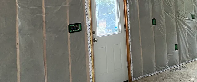 Roxul batts installed in the walls, covered by 6mil poly with taped seams
