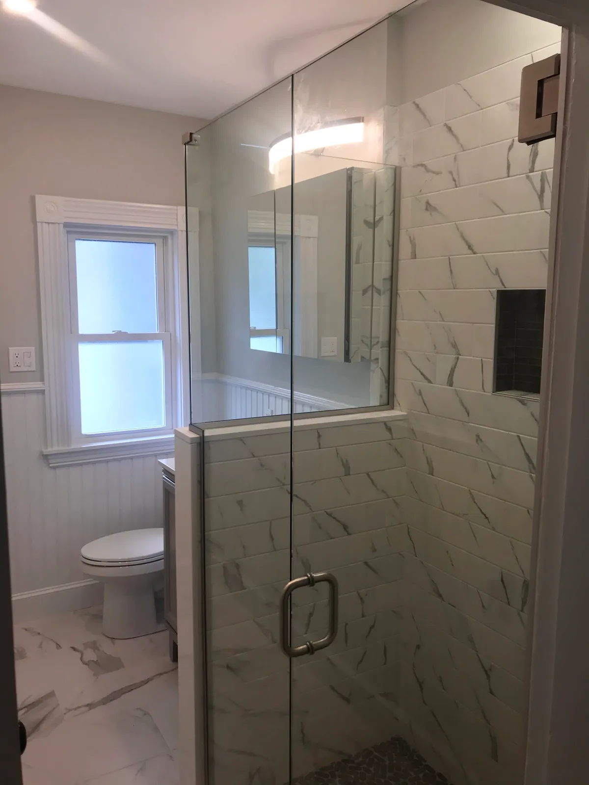Bathroom with frameless glass shower
