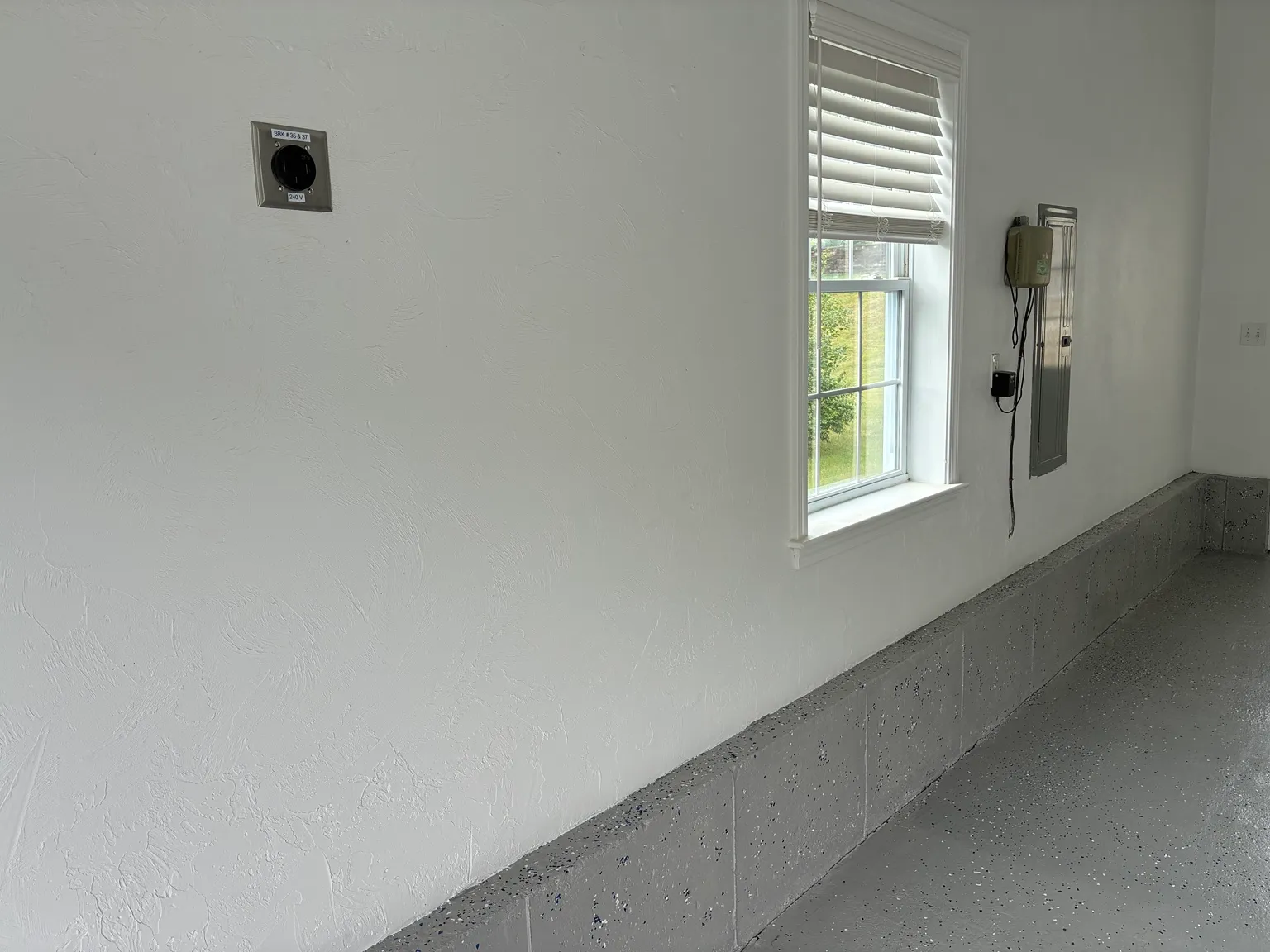 Garage prepared for Level 2 EV charging with 240V NEMA 14-50 receptacle